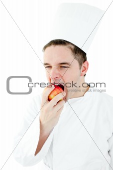 Hungry cook eating a red apple 