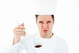 Young male cook tasting a bad soup a