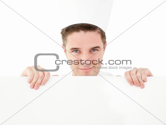 Joyful young cook holding a white paper smiling at the camera