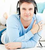 Lively young man listen to music with headphones 