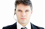 Assertive young businessman with headphones looking at the camer