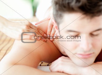 Relaxed young man having a back massage 