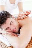 Charming young man in an acupuncture therapy in a Spa center 