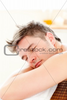 Portrait of a relaxed man lying on a massage table 