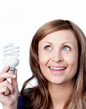 Delighted woman holding a light bulb 