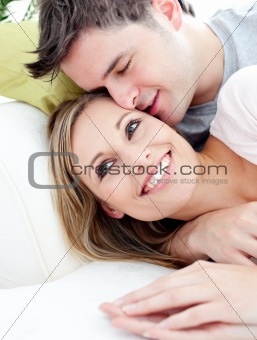 Portrait of a loving boyfriend hugging his girlfriend on the sof