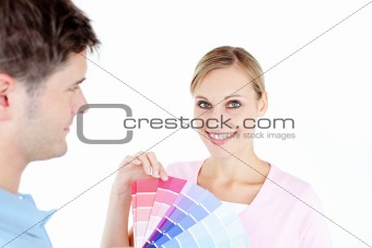 Smiling young woman choosing colors for painting a room 