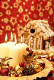 Christmas decoration with candles and gingerbread house