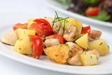 Fried potatoes with mushrooms and cherry tomatoes