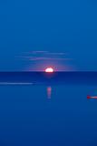 croatia, istria - full moon setting over adriatic sea at dawn