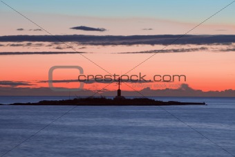 croatia - colorful sky and clouds after sunset over islet with lighthouse
