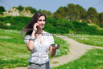 Pretty woman speaking on phone with compass