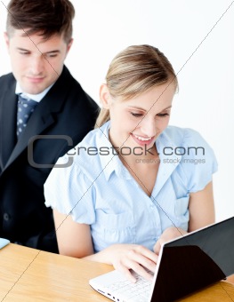 Beautiful young businesswoman using her laptop at home 