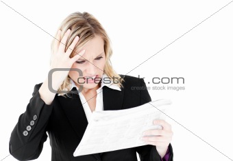 Frustrated businesswoman looking at a newspaper 