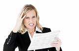 Furious businesswoman looking at a newspaper 