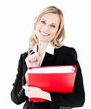 Glowing businesswoman holding a folder smiling at the camera 
