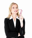 Thoughtful young businesswoman  holding glasses