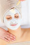 Portrait of a relaxed woman having a spa treatment in a health center with white cream