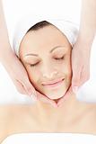 Pretty young woman enjoying a facial massage 