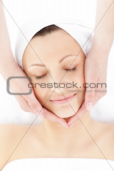 Pretty young woman enjoying a facial massage 