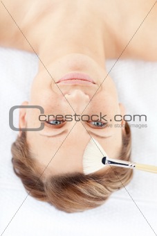 Delighted young woman receiving a beauty treatment 