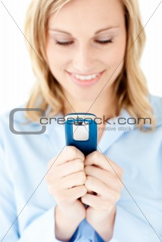 Concentrated blond woman sending a text against white background