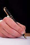 businessman signing a document  with a fountain pen