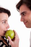 Woman seducing a man eating an apple
