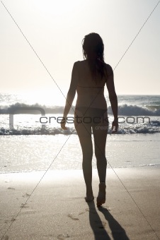 walking at shore against sun