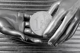 silver euro coins in futuristic robot hands