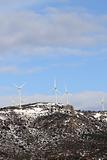 aerogenerator windmills on snow mountain