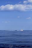 motorboat fisherboat cruising speed on blue sea
