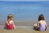 tow sisters sit on beach bathing suit swimsuit