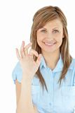 Successful young businesswoman showing OK sign 