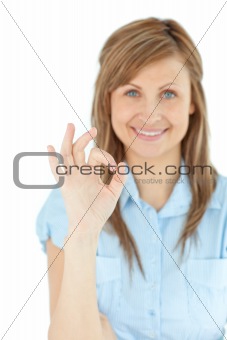 Successful young businesswoman showing OK sign 