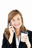 Blond businesswoman talking on phone holding coffee 