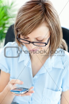 Positive young businesswoman texting 