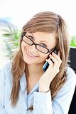 Charming businesswoman talking on phone smiling at the camera 