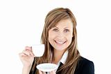 Merry young businesswoman holding a cup of coffee