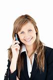 Elegant young businesswoman talking on phone smiling at the came