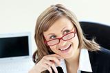 Charming businesswoman sitting on a chair wearing glasses 