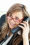 Bright young businesswoman talking on phone wearing glasses