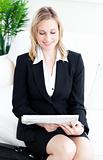 portrait of a business woman in suit reading the paper