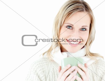 Relaxed woman holding a cup of coffee standing 