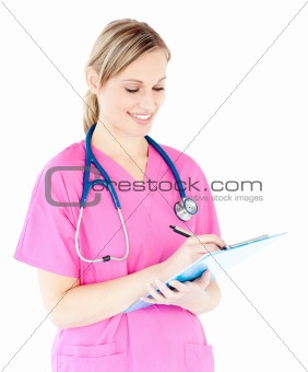 Ambitious female surgeon writing on a clipboard 
