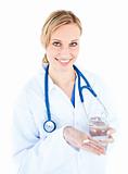 Pretty female doctor holding pills and water 