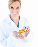 Charming young doctor holding pills 