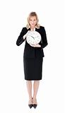 Distressed businesswoman holding a clock 