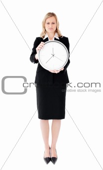 Frustrated businesswoman holding a clock against white backgroun