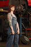 Female mechanic with tire iron